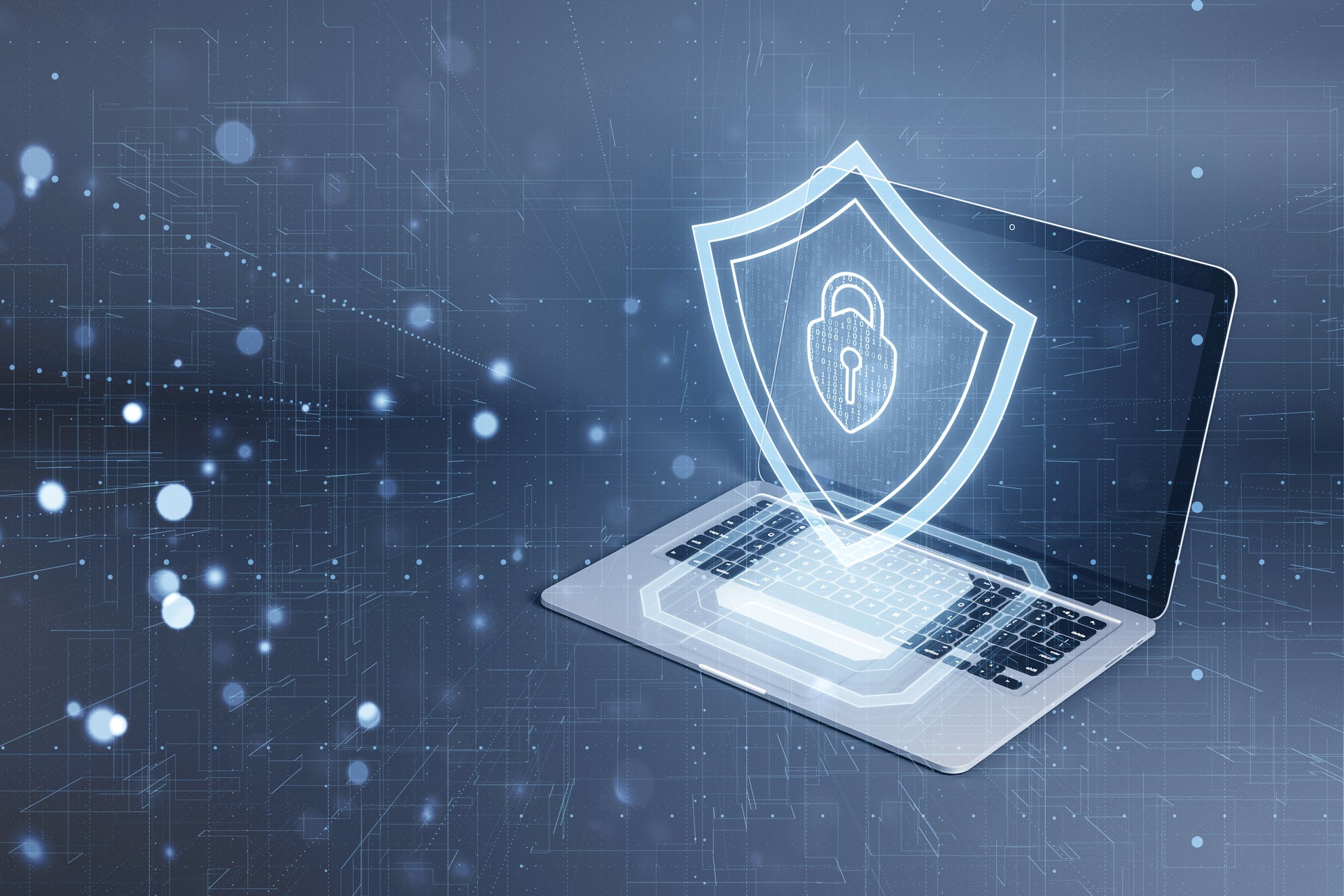 Laptop with a digital shield depicting cybersecurity concept on a blue tech-inspired background